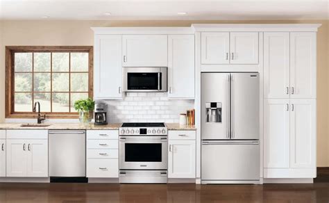 antique white cabinets with black stainless steel appliances|black fridge in white kitchen.